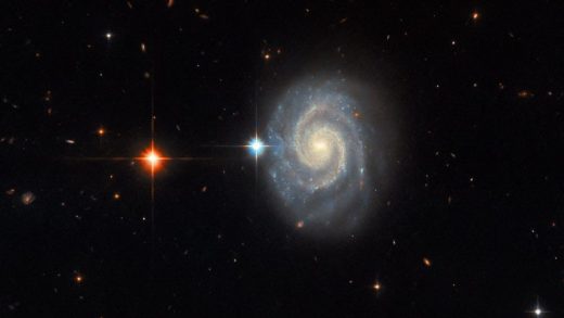 Hubble image shows the "forbidden" light coming from a distant spiral galaxy, MCG-01-24-014